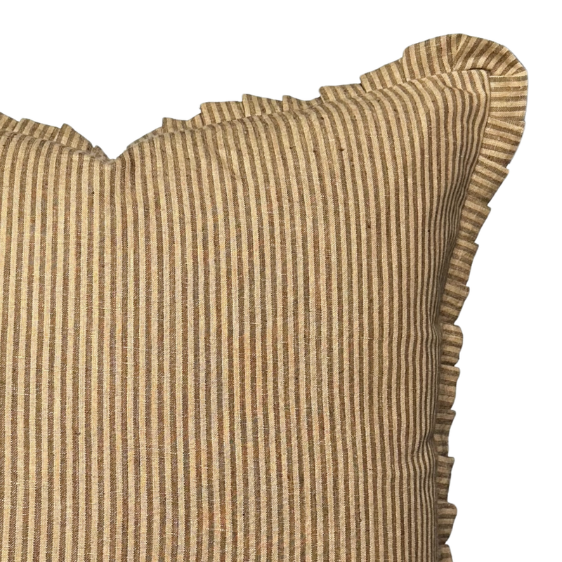 Striped pillow with ruffled edge on a white background