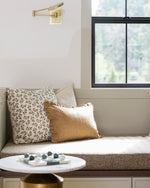 Cozy nook with pillows and a small table by a window
