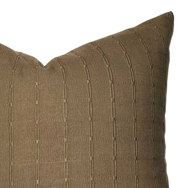 Close-up of a brown textured pillow on a white background