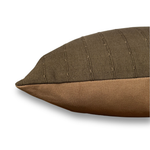 Brown pillow with textured surface on a white background